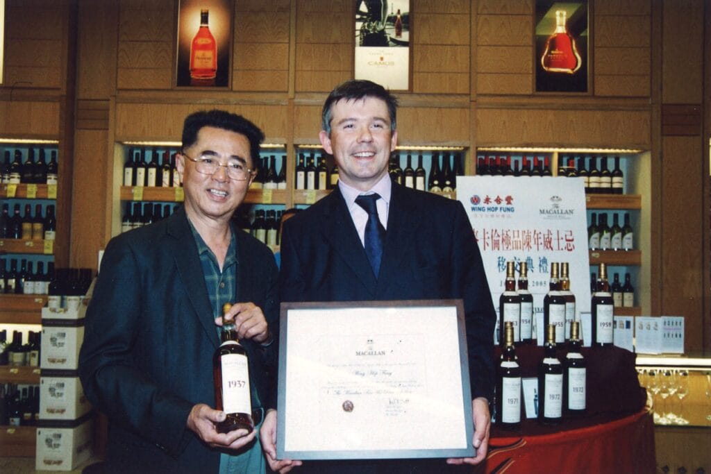A photo documenting the ceremony, in 2005, during which then The Macallan Brand Ambassador Marc Izatt delivers The Macallan Fine & Rare collection to Wing Hop Fung’s ownership. Image courtesy of Wing Hop Fung