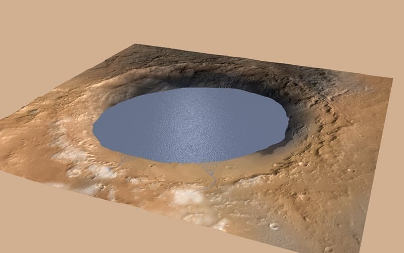 Esta ilustración muestra un lago de agua lleno parcialmente el Cráter Gale de Marte. Habría sido llenado por la escorrentía de la nieve derritiéndose en el borde norte del cráter. La evidencia de antiguos arroyos, deltas y lagos que el rover Curiosity de la NASA ha encontrado en los patrones de depósitos sedimentarios en Gale sugiere que el cráter albergó un lago como este hace más de tres mil millones de años, llenándose y secándose en múltiples ciclos durante decenas de millones de años. Credits: NASA/JPL-Caltech/ESA/DLR/FU Berlin/MSSS
