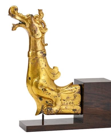 Lot 77  An Important and Very Rare Large Gilt-Bronze 'Dragon' Terminal  Han Dynasty  Estimate: HK$2,500,000-3,500,000  Sold for: HK$3,502,500