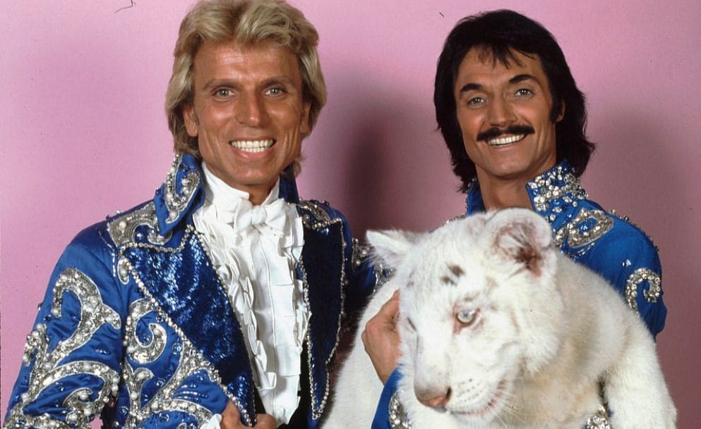 Siegfried & Roy wearing a pair of blue satin costumes worn on stage (c. 1980s)
