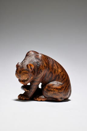 a wood netsuke of a tiger by Tomokazu, Gifu, mid-19th century sold for €63,900